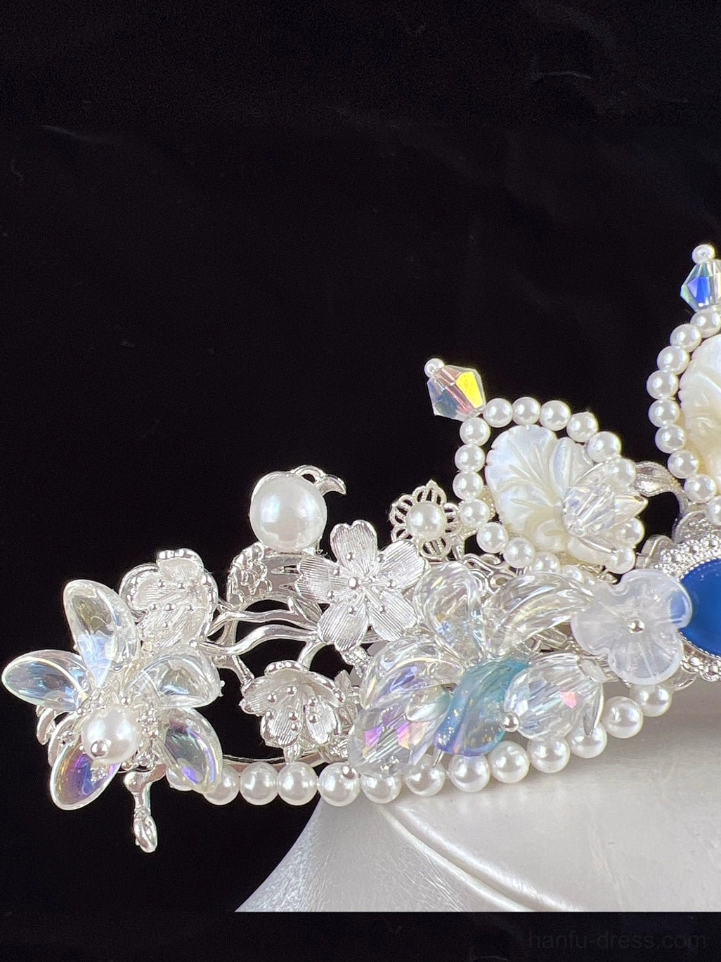 Close up of blue crystal fairy tiara for hanfu showing delicate silver tone metal flowers faux pearls iridescent glass ornaments and gemstone accent