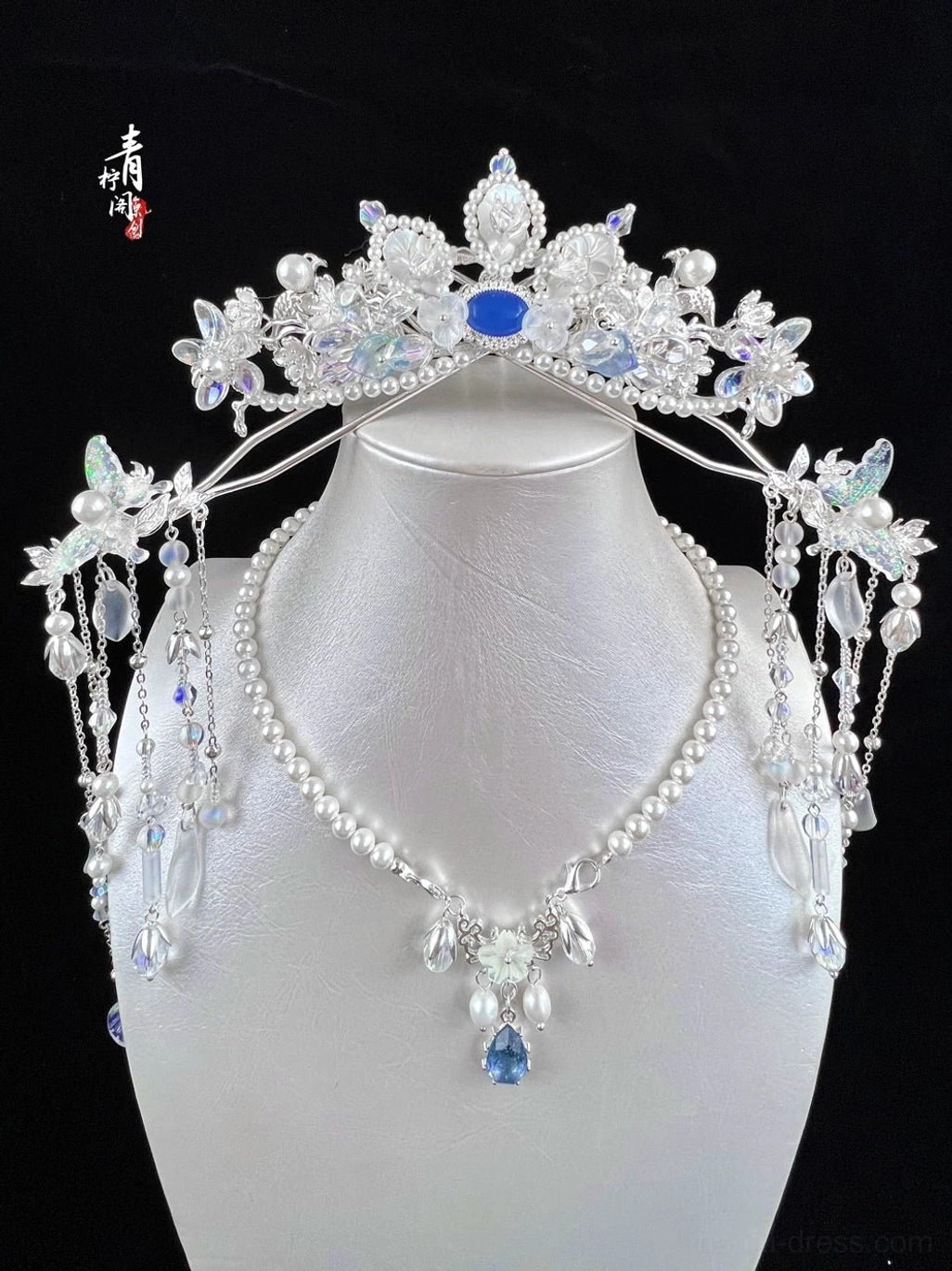 Chinese style fairy tiara and coordinating jewelry styling displayed on mannequin with blue gemstone floral crystals pearl details and dangling tassels