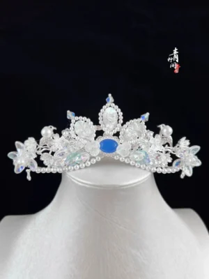 Blue crystal fairy tiara hanfu hair accessory displayed on mannequin head with silver tone floral ornaments faux pearls and iridescent crystal drops