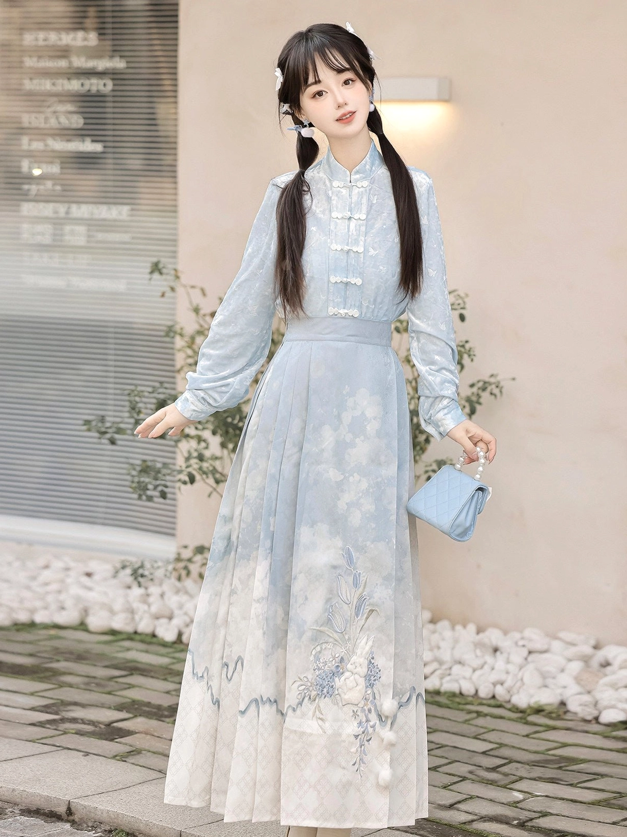 Blue floral Mamianqun horse face skirt styled with a light blue frog button Chinese style top in an outdoor street scene