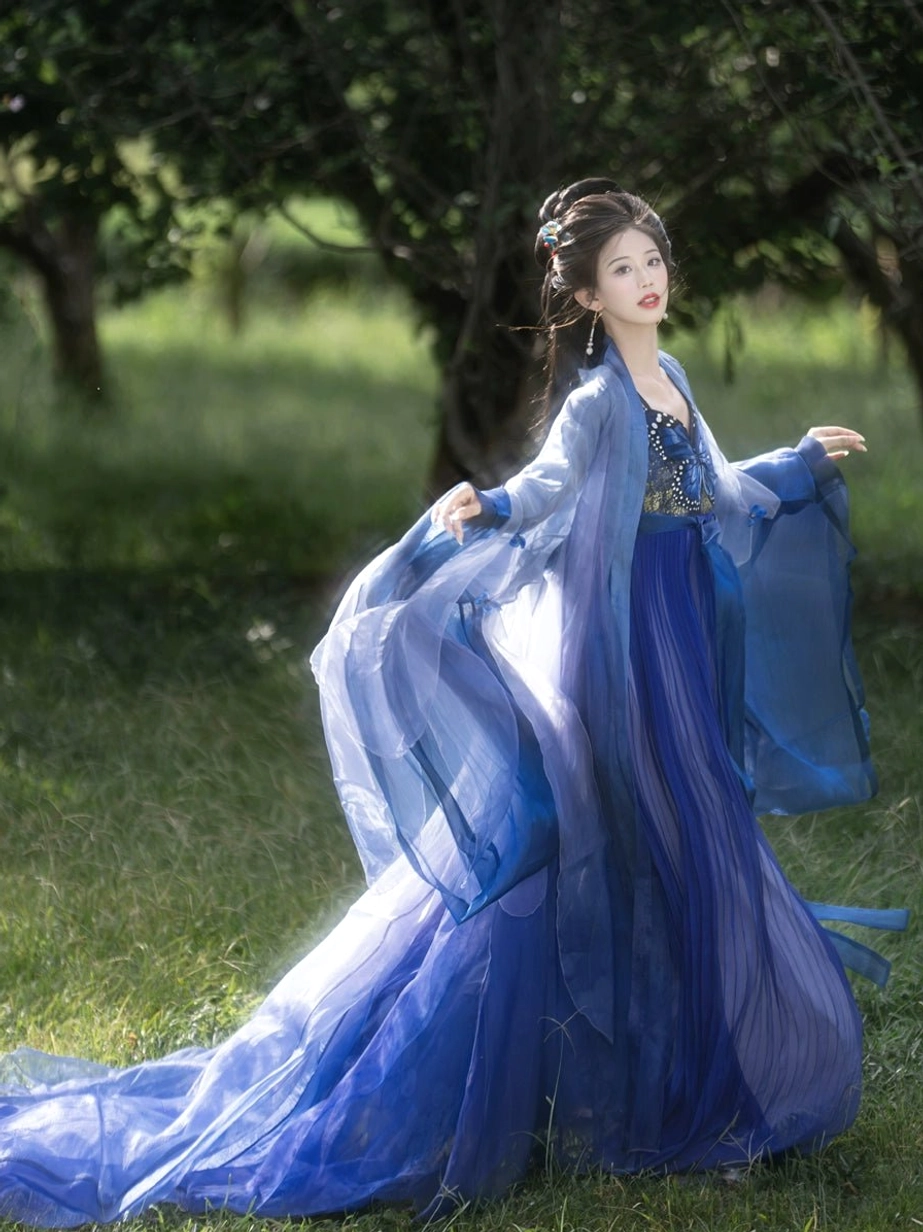 Blue gradient Tang Dynasty Hanfu Heziqun shown from the front with light blue sheer shawl, deep blue pleated skirt, embroidered bodice, long skirt train, and layered flowing fabric