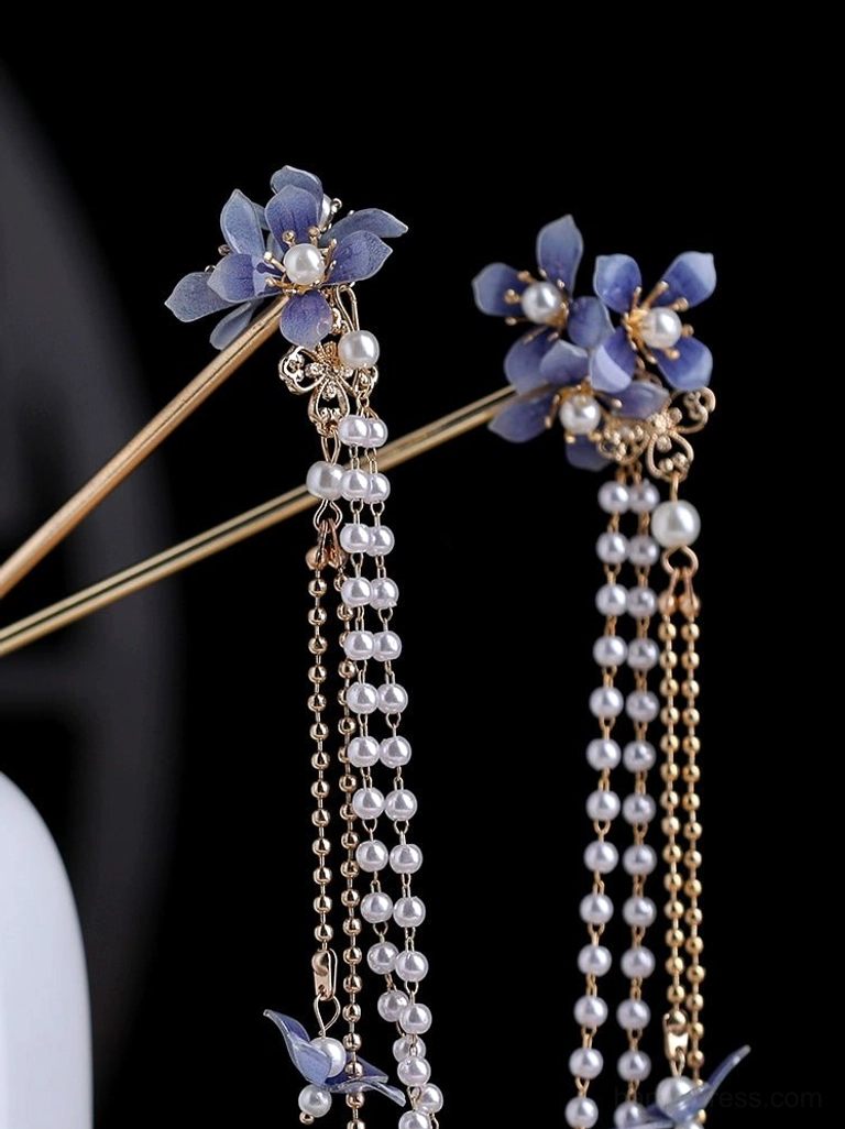 Close-up view of blue hydrangea decorative hair pin with pearl flower details and mixed gold and pearl chain tassels