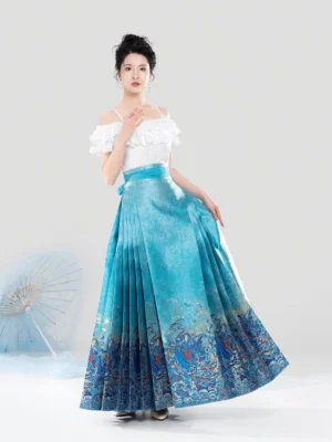 Full-length front view of a model wearing a white ruffled off-shoulder top with a flowing aqua blue Mamian skirt, styled with a traditional Chinese paper umbrella