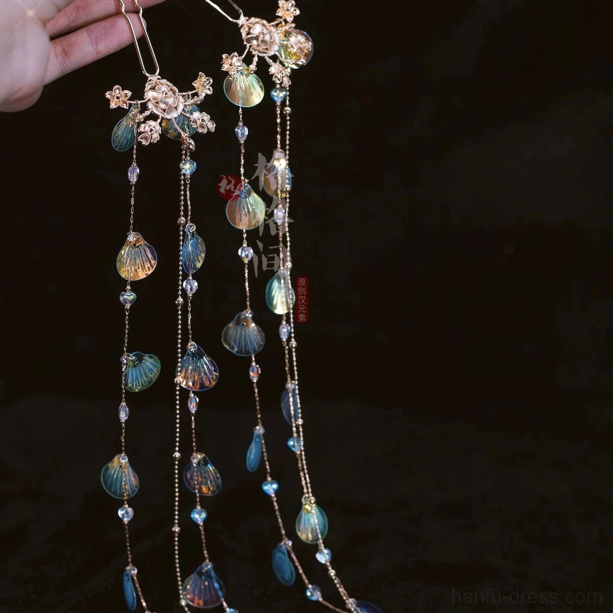 Blue green mermaid shell tassel Hanfu hair pins with gold flower hairpin mounts fine chains and matching bead details held in hand