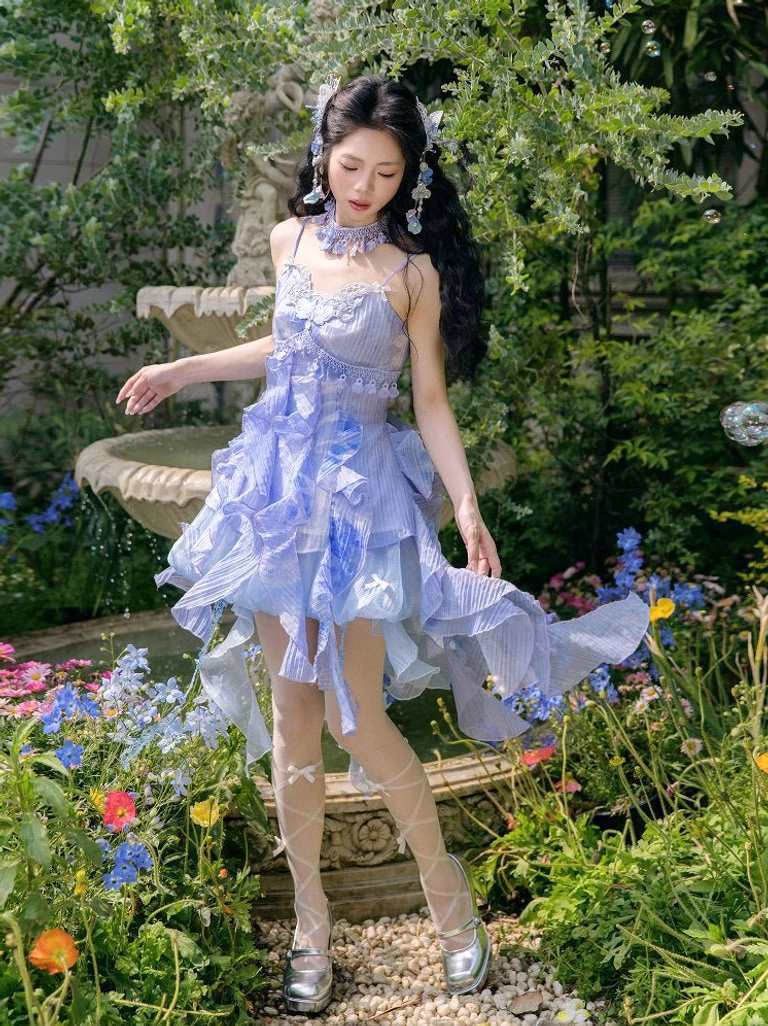 Blue Moon Lake modern Hanfu fairy slip dress in blue lilac gradient with layered ruffle hem shown in a garden fountain setting
