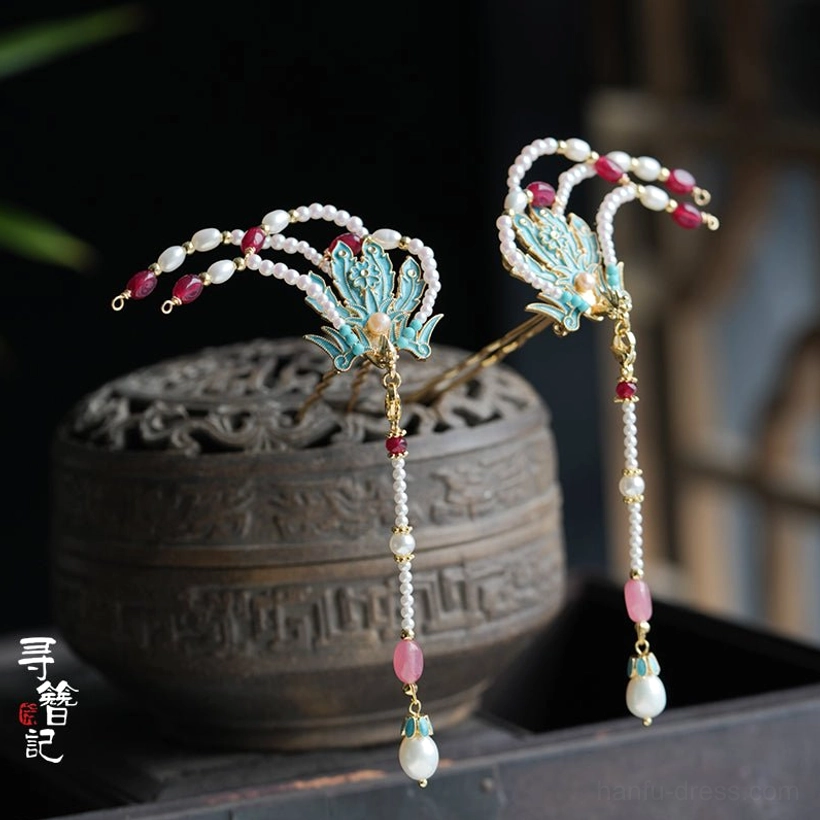 Side view of blue phoenix Chinese hairpins with gold-tone metal, pink beads and dangling pearl tassels