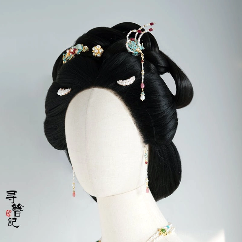 Blue phoenix hanfu hairpin worn on a traditional Chinese coiffure with matching floral clips earrings and necklace