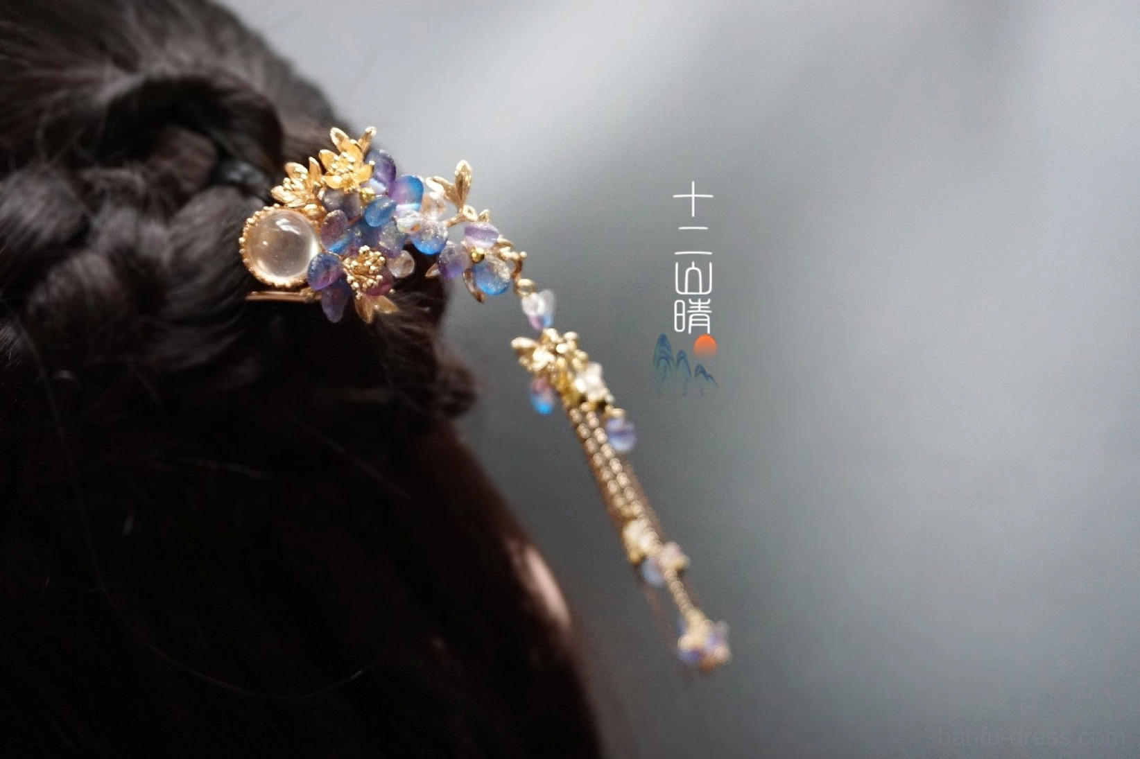 Blue purple floral tassel Hanfu hairpin worn in a traditional braided Chinese hair bun