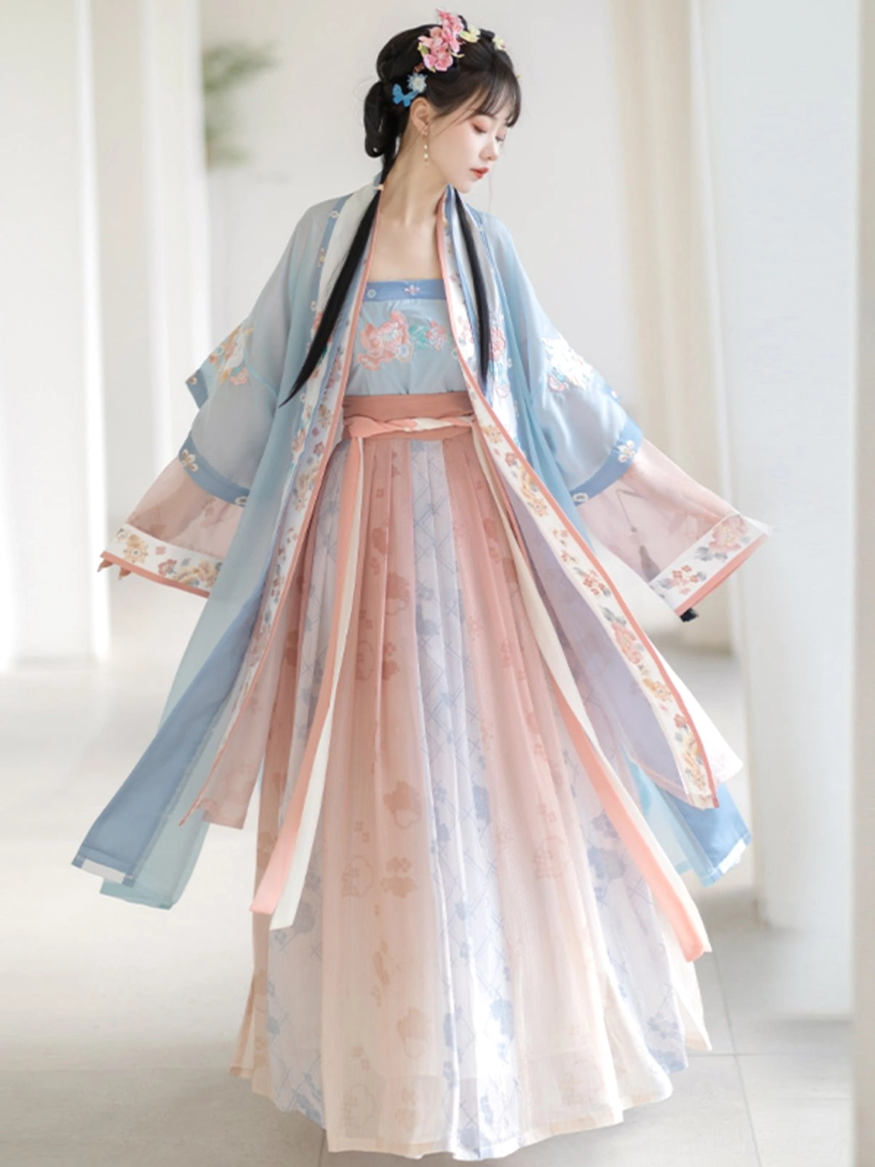 Blue Song Dynasty Hanfu Qiyao Ruqun shown from a three-quarter side view with high-waisted skirt, floral embroidered cuffs, flowing gradient fabric, and elegant traditional styling
