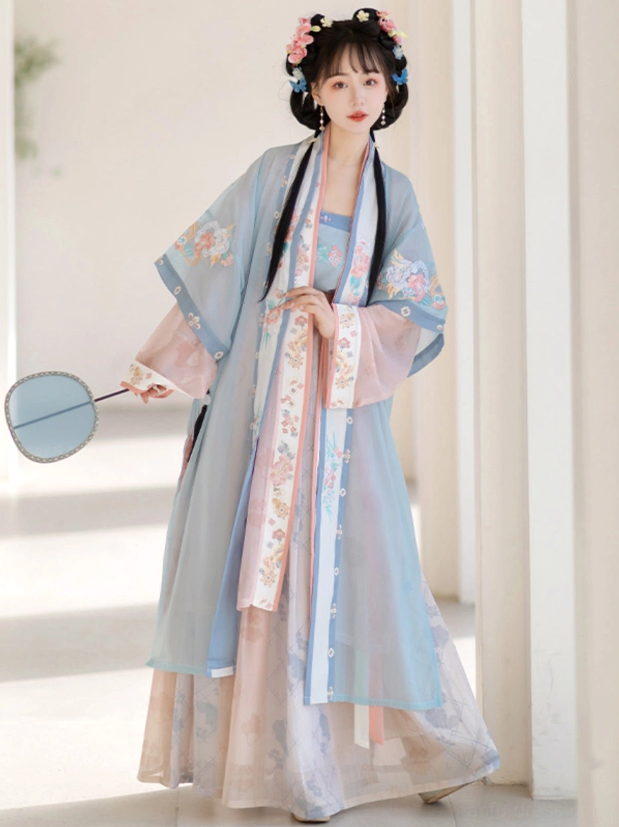 Blue Song Dynasty Qiyao Ruqun Hanfu set in a full-body front view with light blue embroidered Beizi coat, pink gradient skirt, round silk fan, and traditional hairstyle