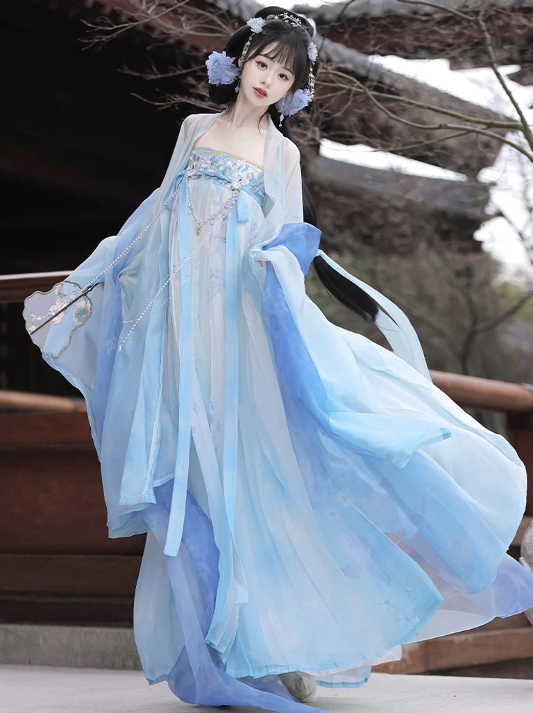 Blue Tang Dynasty Hanfu dress with flowing skirt, sheer sleeves, subtle floral patterns, and matching blue hair ornaments in motion