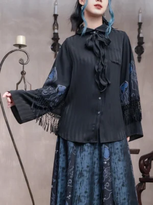 Close-up view of black pinstripe modern Hanfu shirt with navy-blue embroidered sleeves, flowing tassel cuffs, front buttons, and detachable bow necktie