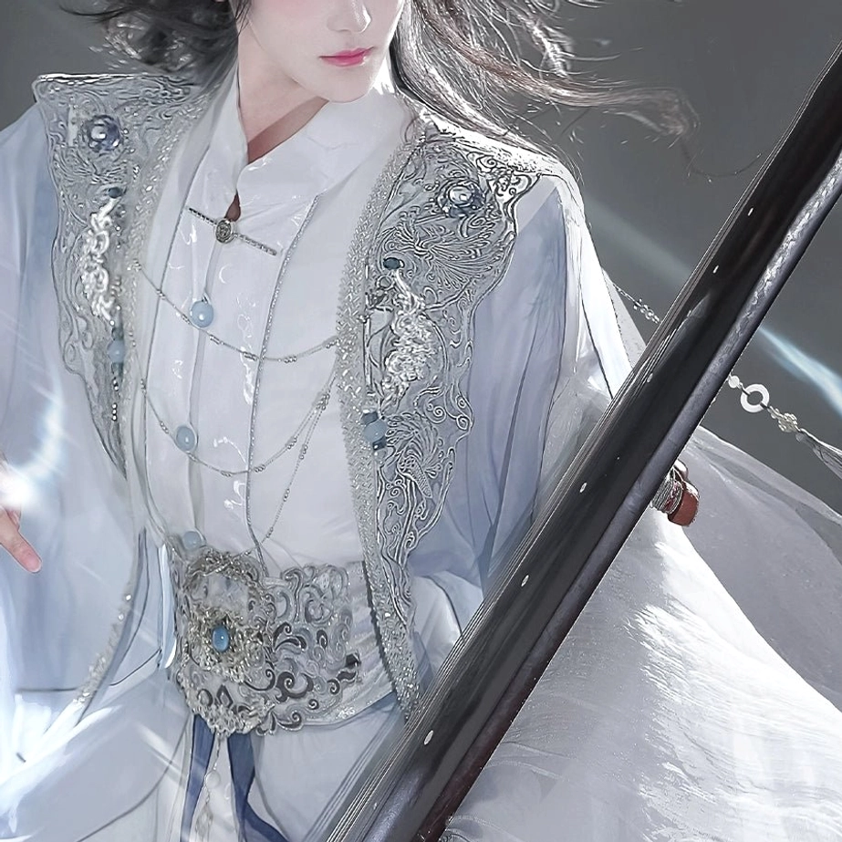 Detailed side view of a blue and white Hanfu outfit showing silver embroidered shoulder trim, layered white inner wear, blue jade-inspired accessories, and an ornate silver waist belt