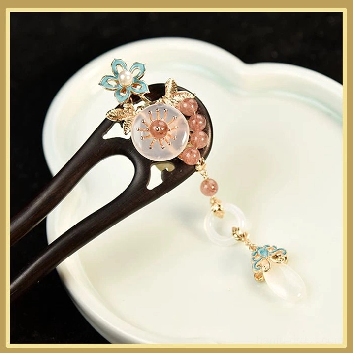 Close-up of blue floral ornament pink bead and tassel detail on blush Chinese hair stick for Hanfu accessories