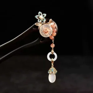 Blush floral tassel Chinese hair stick close-up with blue enamel flower pink bead chain pale jade-style pendants and dark double-pronged hairpin