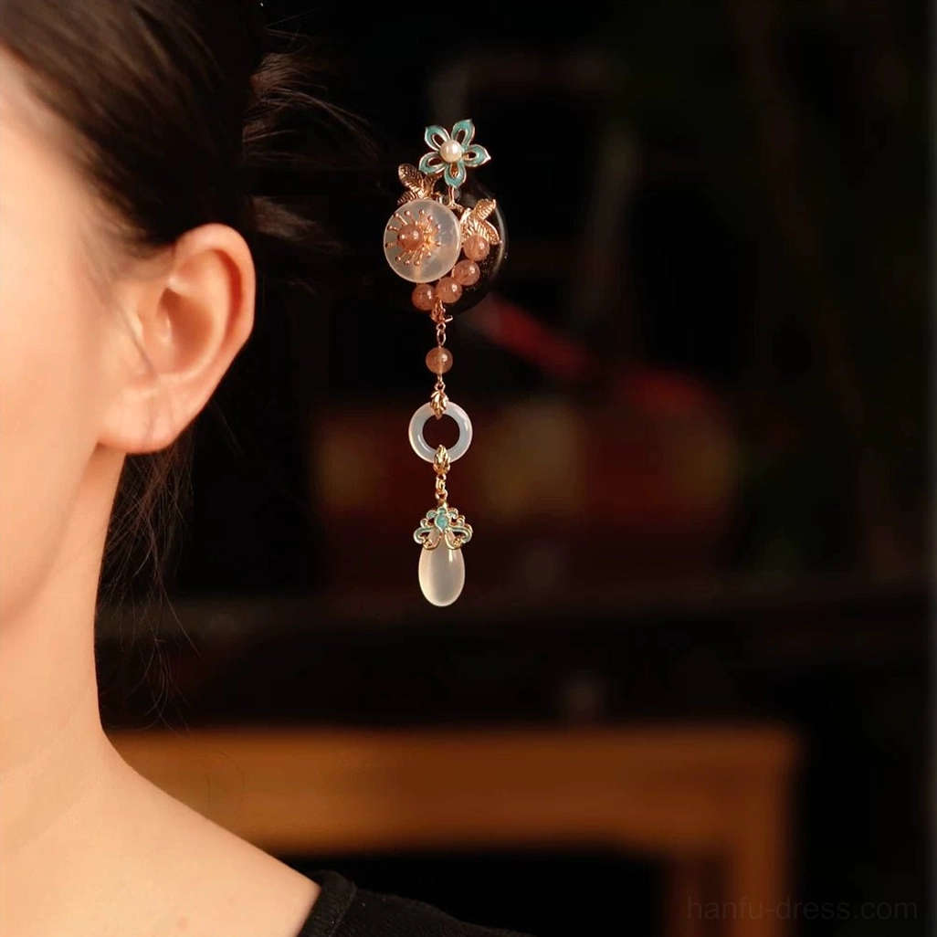 Model wearing blush floral tassel Chinese hair stick in an elegant updo for Hanfu inspired hairstyle styling