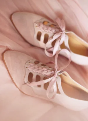 Top view of blush pink Chinese shoes featuring vintage Mary Jane styling, satin ribbon bow laces, suede vamp, smooth side panels, and decorative cutout details