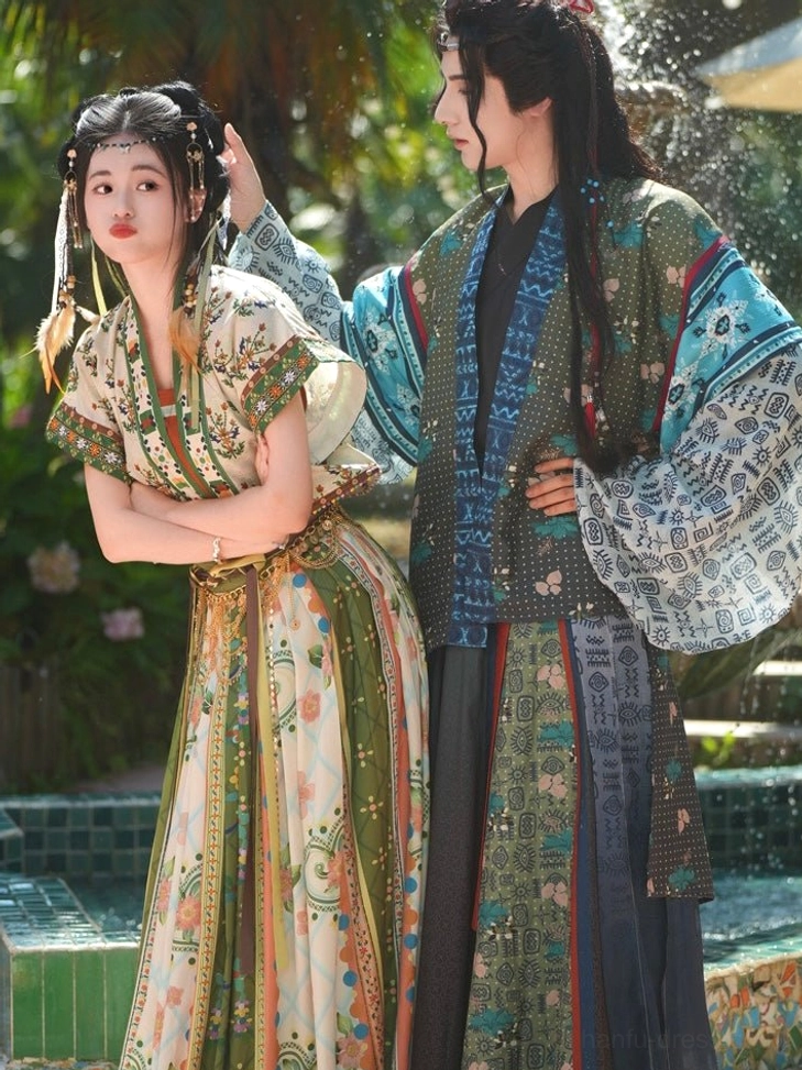 Bodhi matching couple hanfu with floral female skirt and colorful layered male hanfu outfit near fountain