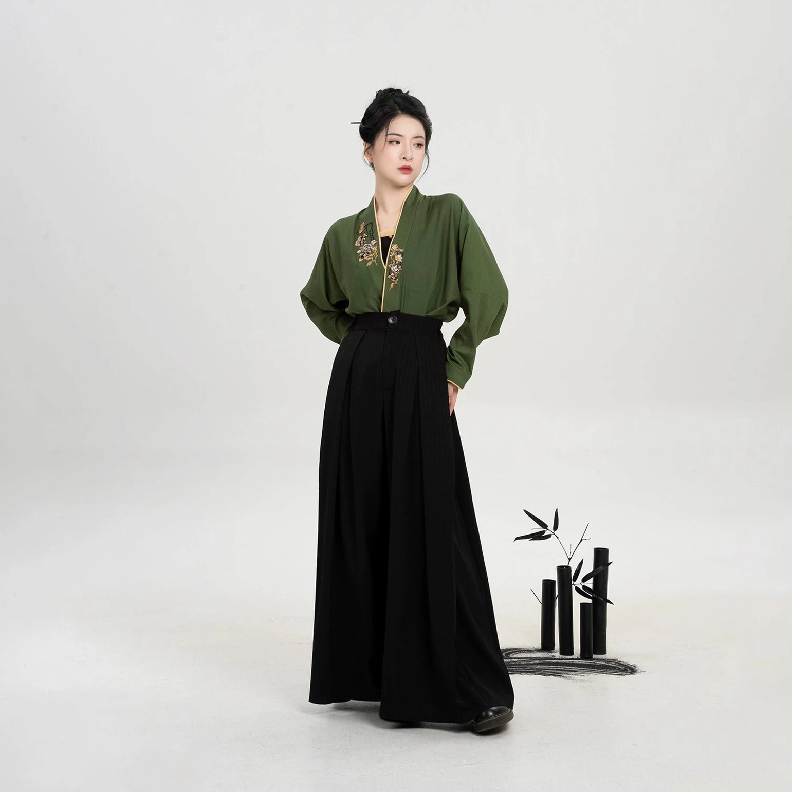 Full Bookmark Butterfly modern Hanfu set with olive green embroidered top black camisole and wide leg pants three quarter view