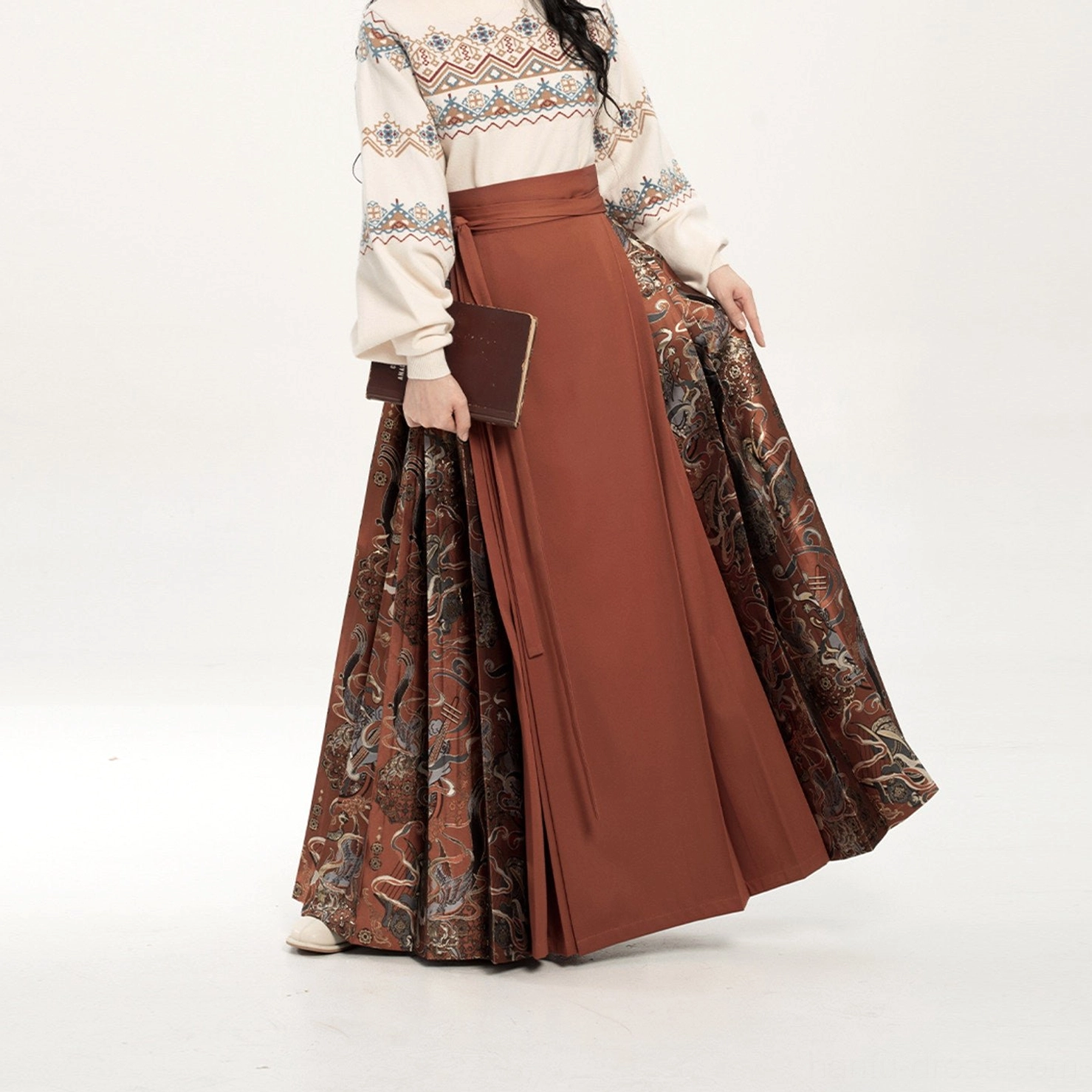 Low-angle full-body view of the brick red mamianqun horse-face skirt showing its full length and graceful fabric drape