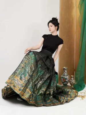 Black Chinese Hanfu top and bronze money tree mamian skirt outfit shown from a three-quarter seated view in a traditional Chinese studio setting