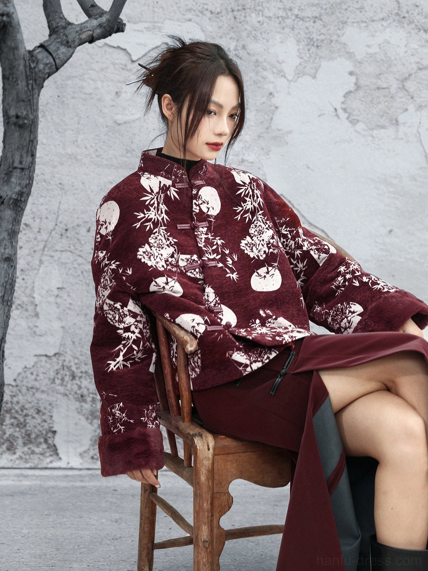 Burgundy modern Hanfu chenille winter jacket shown in three-quarter view with white bamboo leaf, full moon, and floral print, fuzzy cuffs, stand collar, and traditional frog fasteners