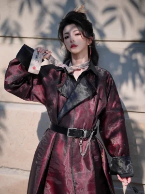 Burgundy and black Tang-inspired demon Hanfu robe front close-up with jacquard fabric, black lapels, waist belt, and chain accent