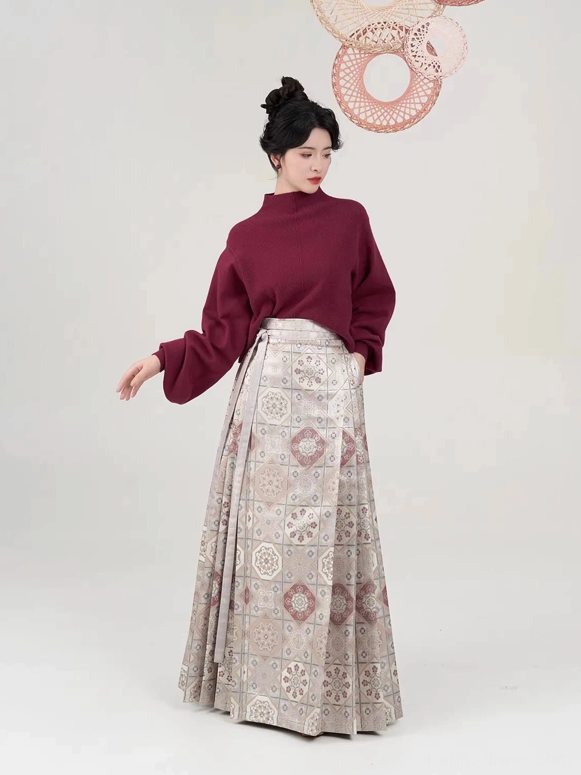 Burgundy cropped mock neck sweater paired with pleated brocade mamian skirt in traditional Hanfu style