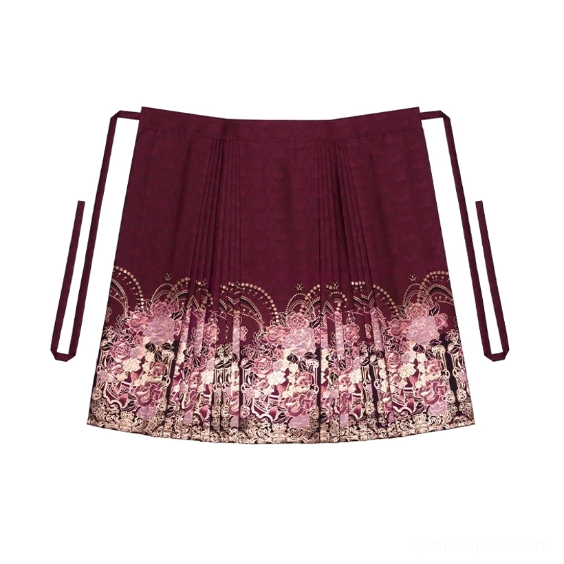 Flat-lay view of the burgundy pleated mamianqun with long side ties and ornate rose and gold floral decoration at the hem