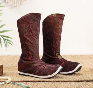 Front view of burgundy men's traditional Chinese Hanfu boots with marbled fabric, gold thread patterns, upturned square toes, and white rubber sole edges