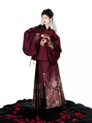 Front view of the burgundy Ming-style Hanfu outfit showing its wide sleeves, embroidered cuffs, and coordinated pleated mamianqun