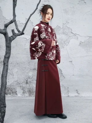 Full-body view of a burgundy Chinese-style winter jacket paired with wine-red wide-leg pants, matching frog details, and bamboo moon floral prints