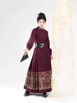 Front full-body view of a burgundy modern Ming Dynasty Hanfu Mamian horse face dress with stand collar, lantern sleeves, leather waist belt, and traditional dragon and cloud patterned hem