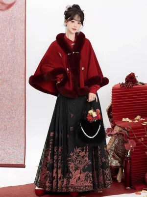 Three quarter view of burgundy plush trim hanfu cloak and black printed mamianqun skirt in a Chinese New Year inspired studio