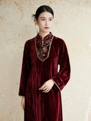 Close-up view of burgundy velvet Hanfu dress neckline featuring floral bead embroidery, gold edging, embroidered stand collar, and decorative cuffs