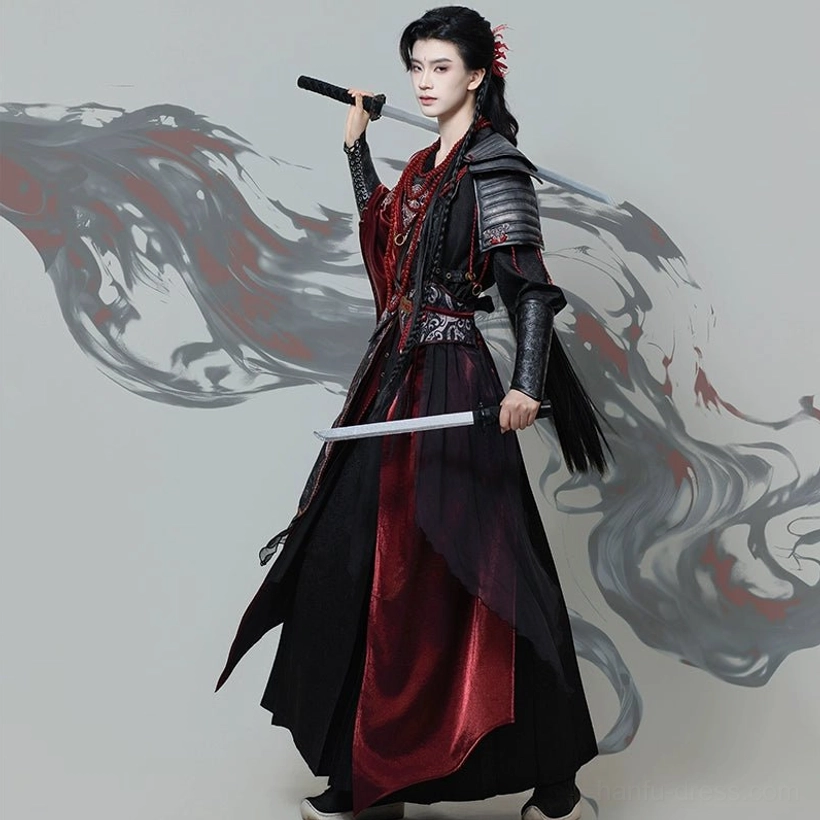 Three-quarter rear view of red and black wuxia hanfu set for men with flowing outer robe, high slit inner layer, shoulder armor, and dual swords