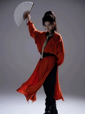 Full body side view of burnt orange Tang Dynasty Hanfu robe in gender neutral wuxia swordsman style with black waist sash