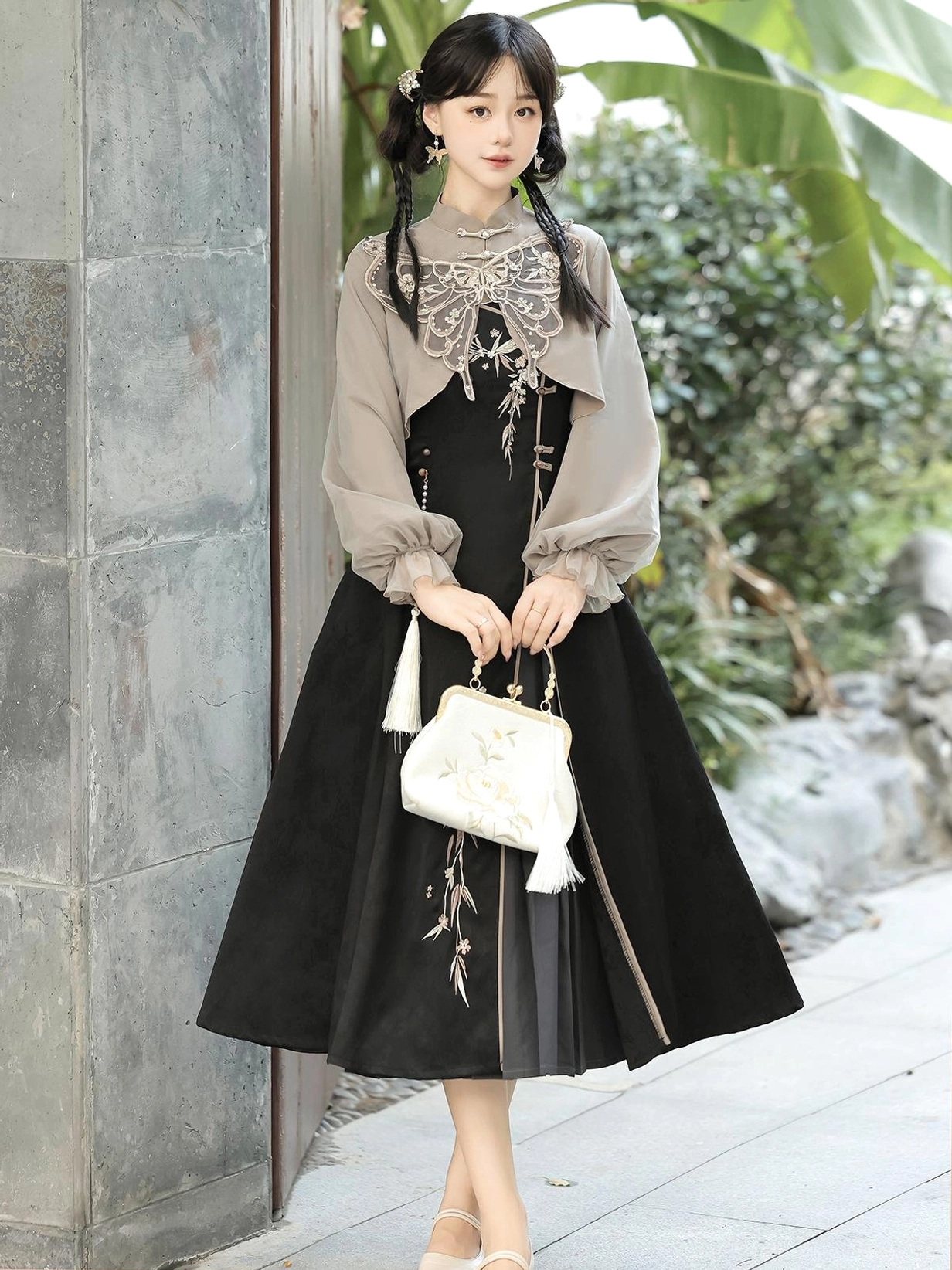 Front view of the Butterfly Ash modern Chinese-style two-piece summer dress with coordinated cropped top, A-line midi skirt, embroidered details, butterfly cloud collar, and tassel pendant styled with a vintage handbag
