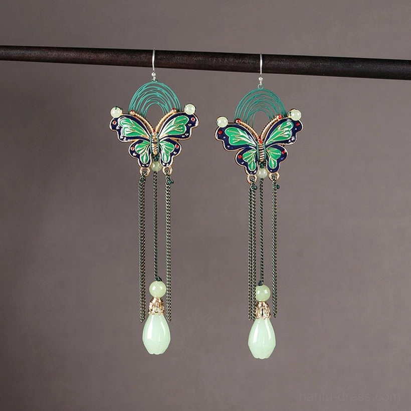 Pair of butterfly teardrop hook earrings with black tassel fringe and light green jade style drops displayed on a neutral background