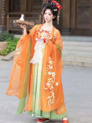 Orange embroidered Tang Dynasty hanfu hezi dress with sheer wide sleeve robe in a traditional Chinese courtyard