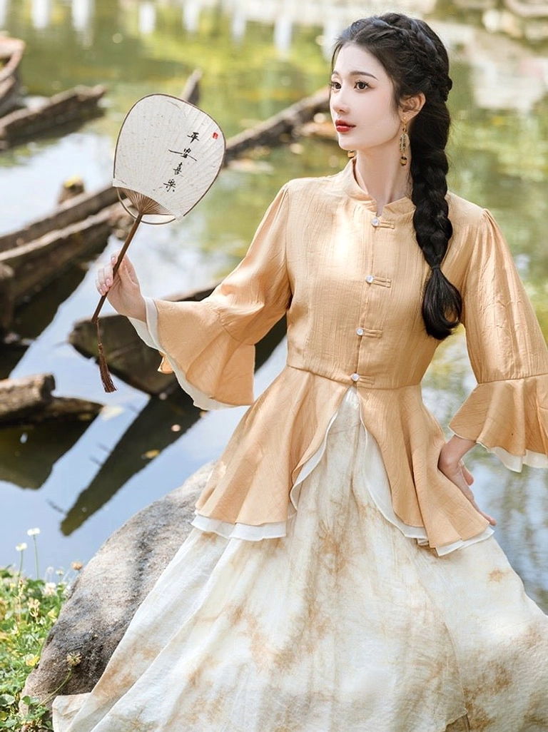 Close view of canary yellow modern Hanfu top with Chinese toggle buttons and layered ruffle bell sleeves paired with a beige tie dye skirt
