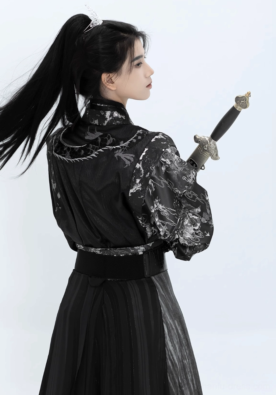 Rear view of Canglan men’s wuxia hanfu costume with embroidered sleeves, black pleated skirt and silver gradient panel
