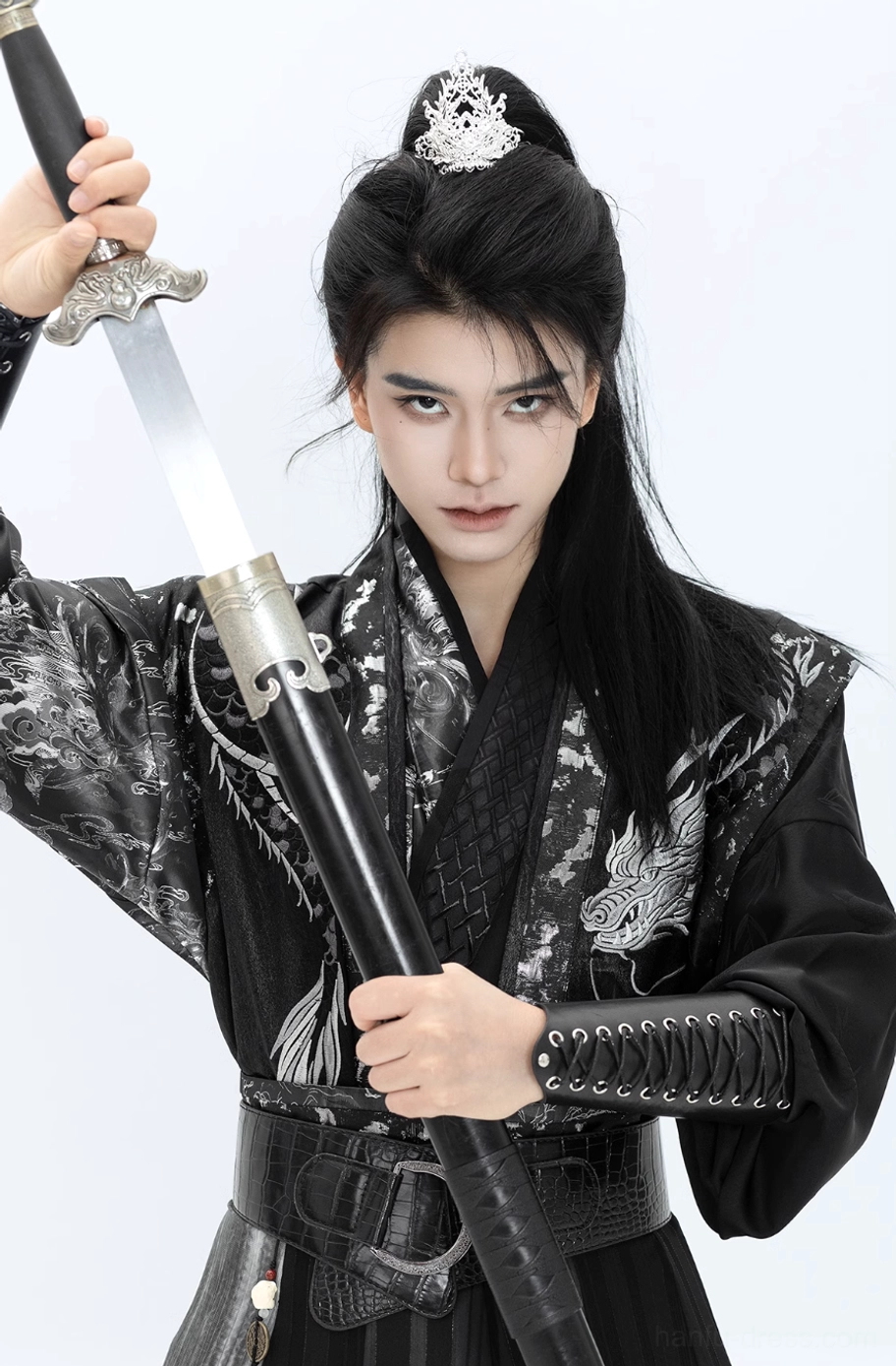 Close-up of Canglan wuxia hanfu silver dragon embroidery on black cross-collar top with lace-up wrist guards
