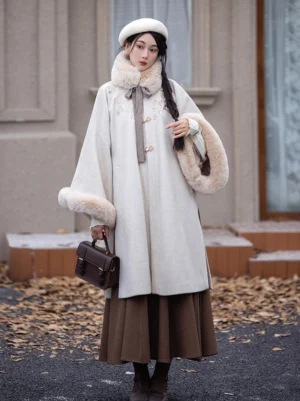 Front full-body view of a cappuccino Ming Dynasty modern hanfu winter coat and brown pleated wrap skirt worn outdoors among fallen autumn leaves