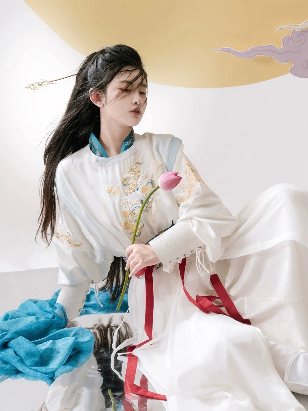 Three quarter side view of celestial God of War fantasy hanfu with golden embroidery blue sheer shawl and red waist sash