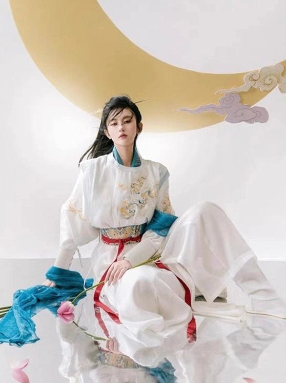 Low angle full body view of flowing white and blue xianxia warrior hanfu costume with long celestial scarf panels