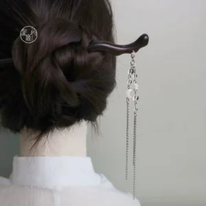 Traditional Chinese hair stick worn in a low bun with moon star tassel hanging elegantly at the back of the neck