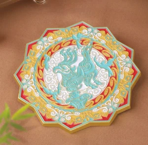 Celestial qilin Chinese pocket mirror shown from above with an embossed mythical beast, octagonal lotus-inspired frame, turquoise red ivory and gold enamel-style details