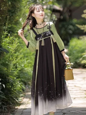 Charlotte modern Tang Dynasty Hanfu two-piece dress with green checked lantern sleeves, chest tassel, and black to ivory gradient star print skirt in garden