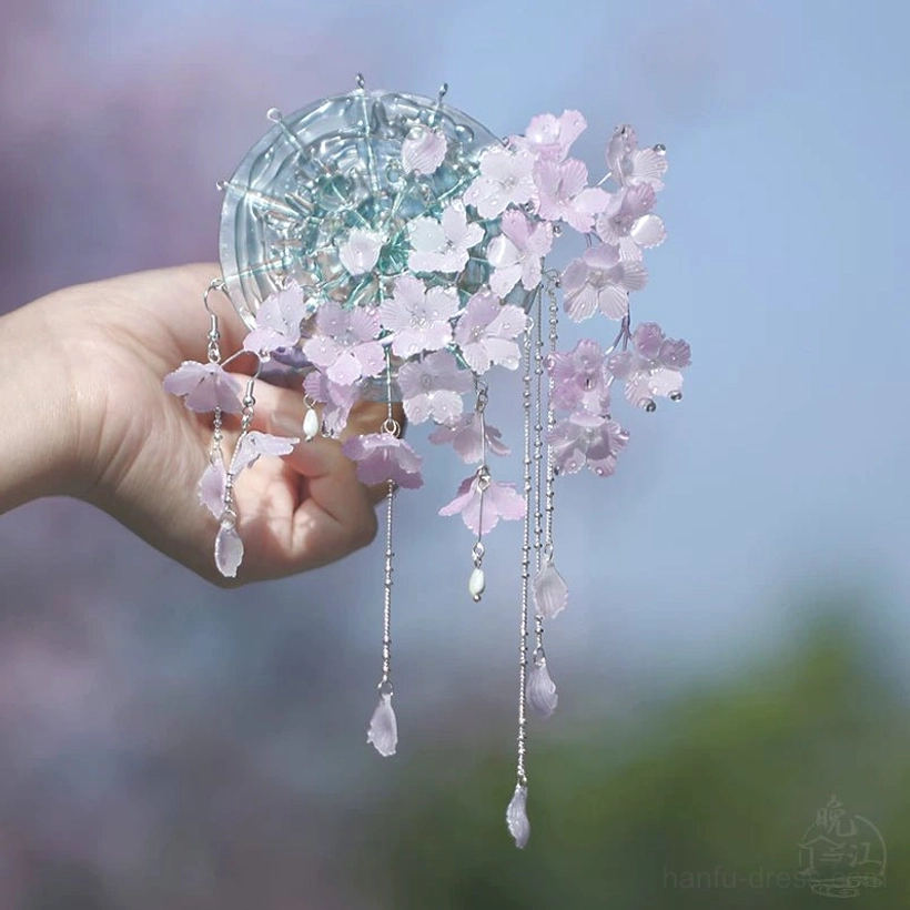 Side close-up of a cherry blossom Chinese hair stick set with balanced pink and purple flower clusters delicate silver chains and hanging teardrop charms